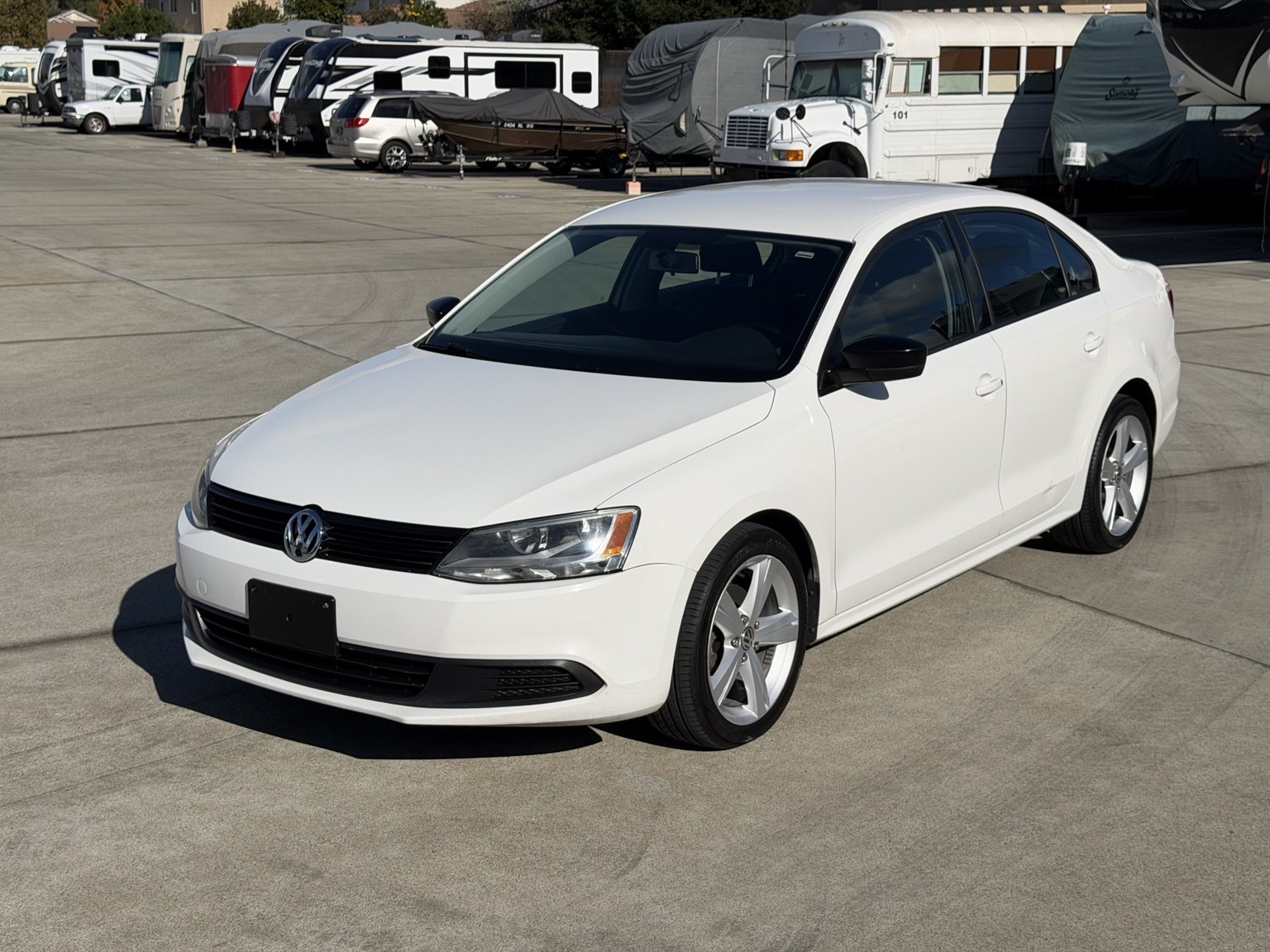 Front three-quarter view of the white 2013 Volkswagen Jetta 2.0L S