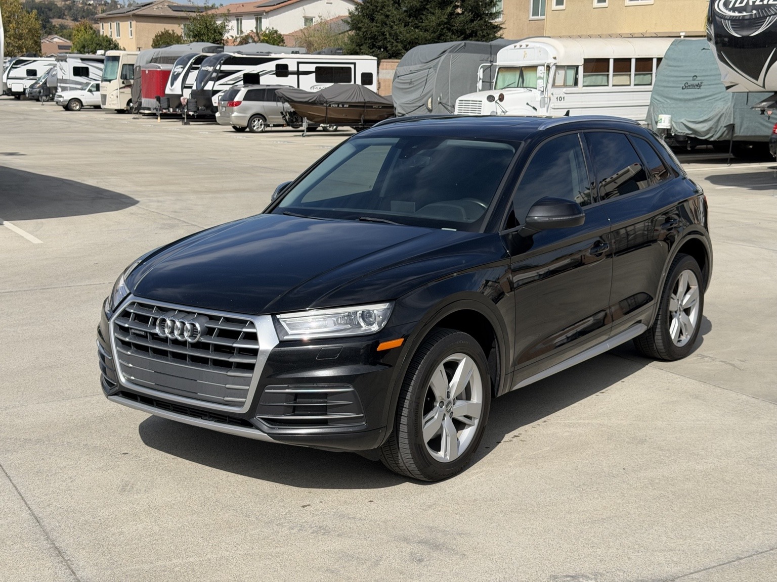 Front three-quarter exterior view of the black 2018 Audi Q5 Premium